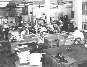 An old-school newsroom, when reporters played pranks by switching the numbers on each other's desks.