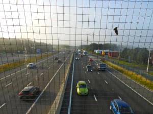 View of motorway outside of Newcastle, England, from a bridge over the carriageway.